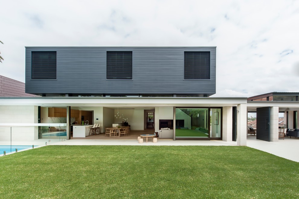 Photo of a contemporary two floor house exterior in Sydney with mixed cladding and a flat roof.