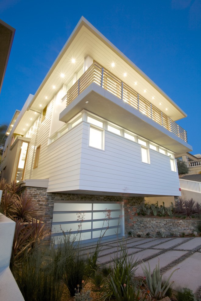 На фото: большой, трехэтажный, деревянный, белый дом в морском стиле с плоской крышей
