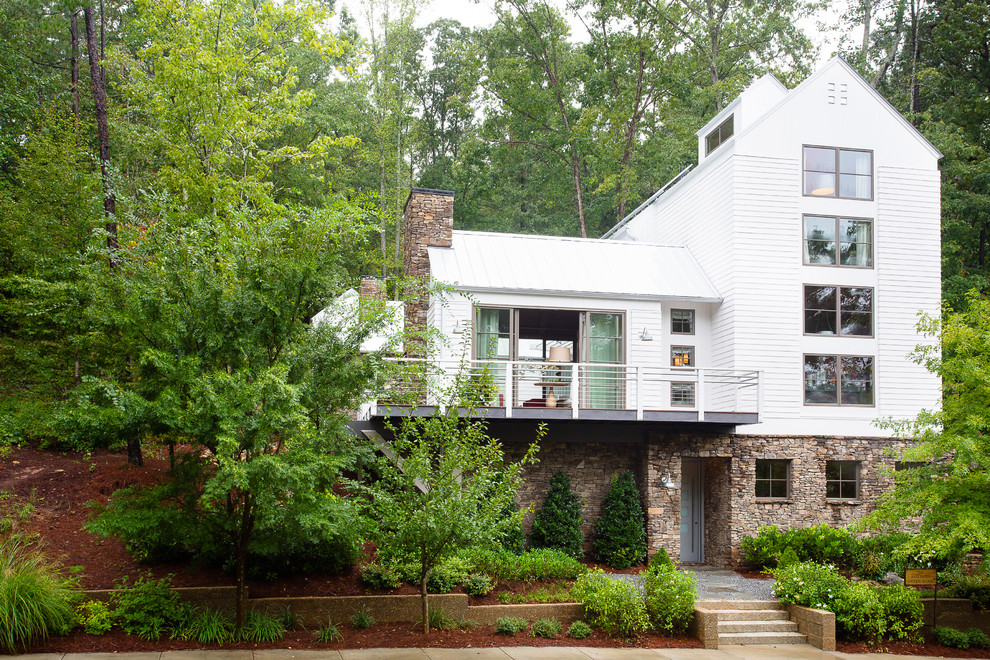 Inspiration for a large and white traditional house exterior in Atlanta with three floors, mixed cladding and a pitched roof.