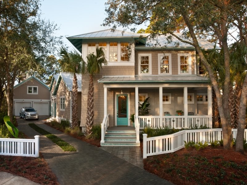 Design ideas for a large and beige coastal two floor house exterior in Jacksonville with vinyl cladding and a pitched roof.