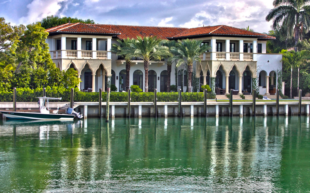 Zweistöckiges Mediterranes Haus mit weißer Fassadenfarbe und Walmdach in Miami