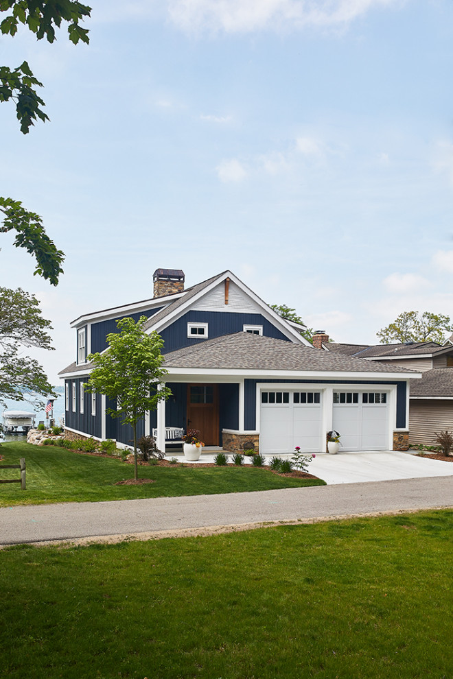 Inspiration for a mid-sized coastal blue two-story concrete fiberboard exterior home remodel in Grand Rapids with a mixed material roof