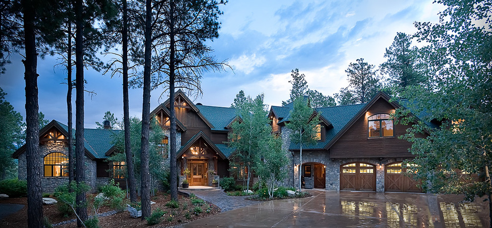 Inspiration for a large rustic three-story mixed siding exterior home remodel in Albuquerque