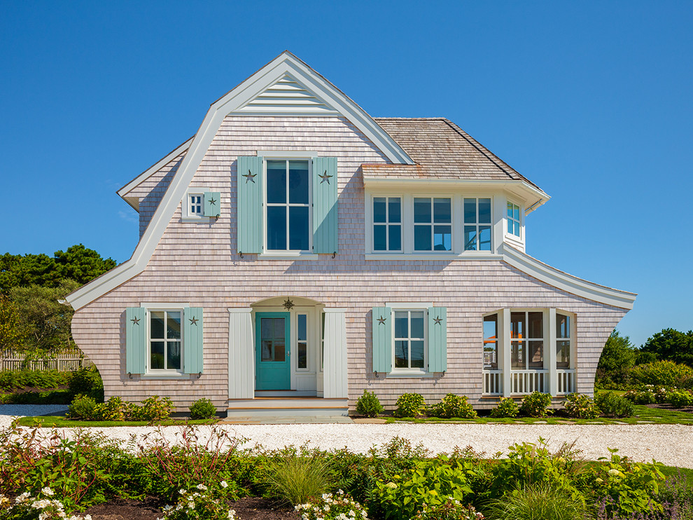Inspiration for a coastal beige two-story wood house exterior remodel in Boston with a shingle roof