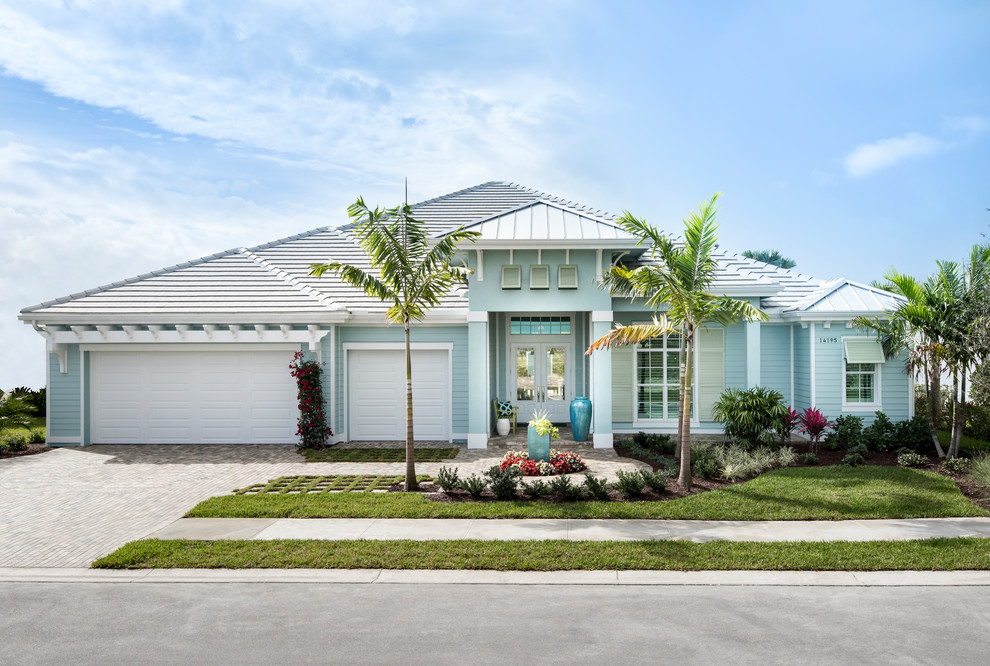 Blue coastal bungalow detached house in Miami with a hip roof.