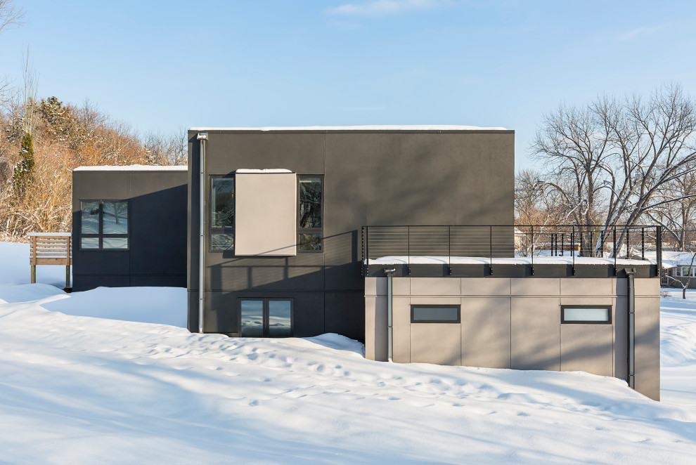 Medium sized and black contemporary two floor render detached house in Minneapolis with a flat roof.