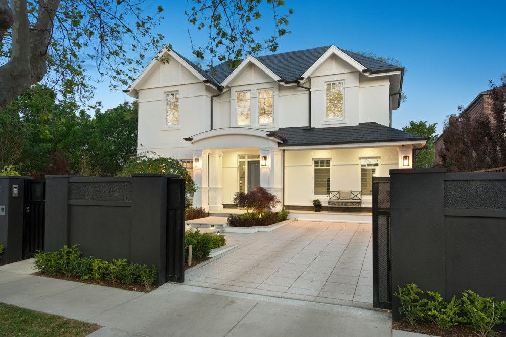 Large and white contemporary detached house in Melbourne with three floors and a shingle roof.