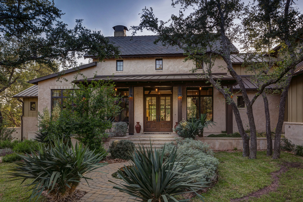 Inspiration for a mid-sized cottage two-story exterior home remodel in Austin