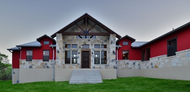 Esempio della facciata di una casa rossa contemporanea a un piano di medie dimensioni con rivestimenti misti e tetto a capanna