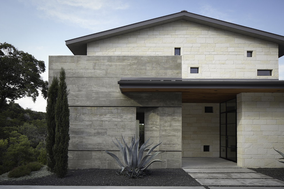 Cette image montre une façade de maison design en pierre.