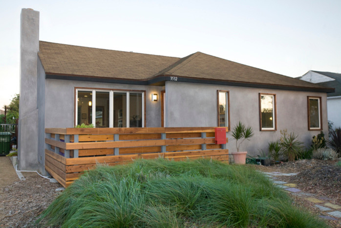 This is an example of a small and gey contemporary bungalow render house exterior in Los Angeles.