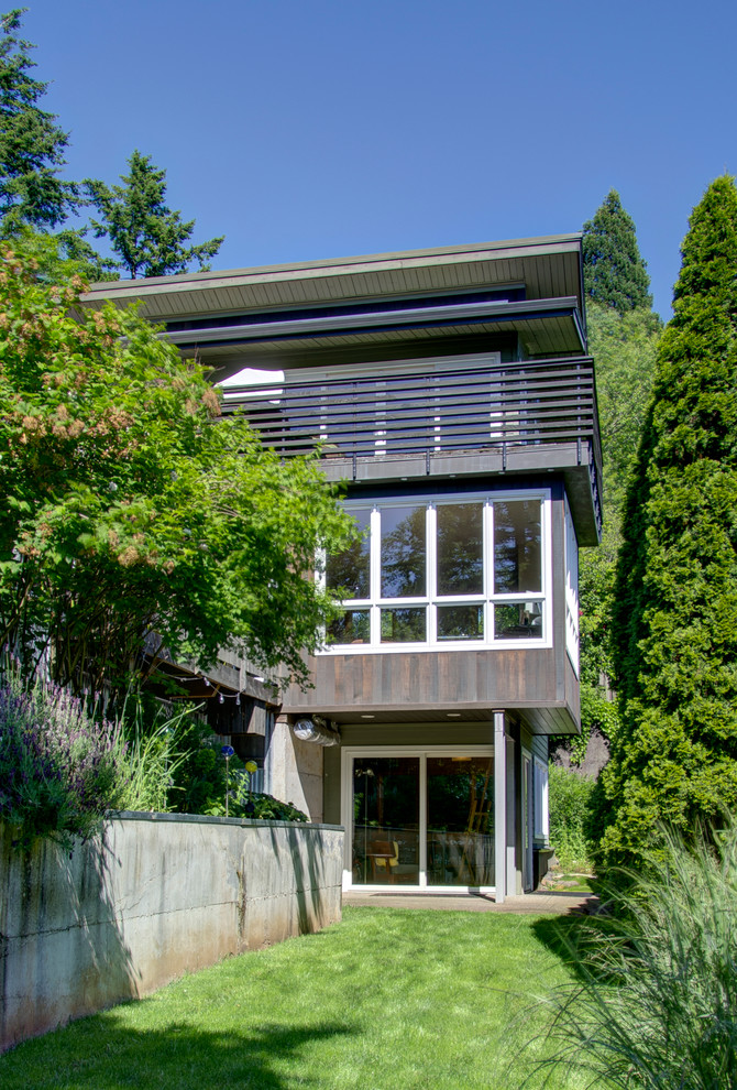 Design ideas for a green modern house exterior in Portland with three floors and mixed cladding.