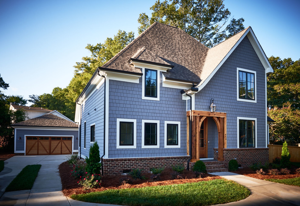 Photo of a medium sized and blue traditional two floor house exterior in Charlotte with wood cladding.