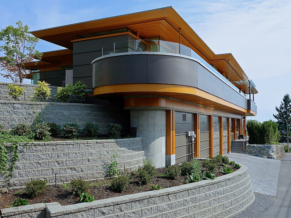 Trendy gray two-story glass house exterior photo in Vancouver with a hip roof