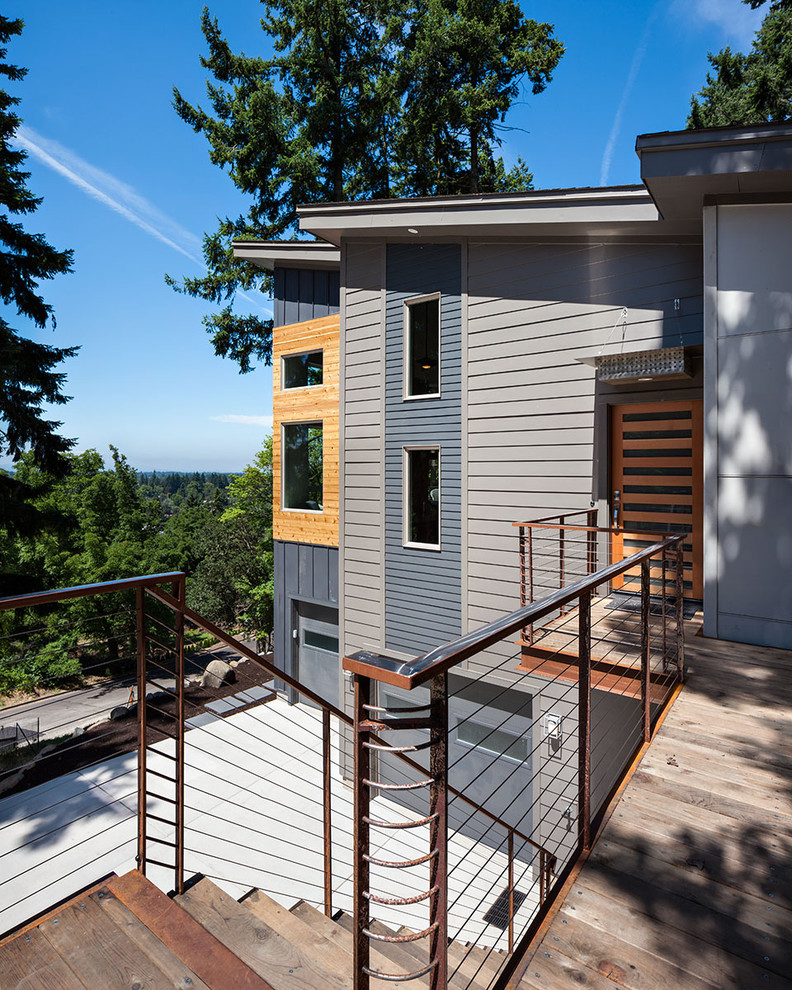 Example of a large trendy gray three-story mixed siding exterior home design in Portland with a shed roof