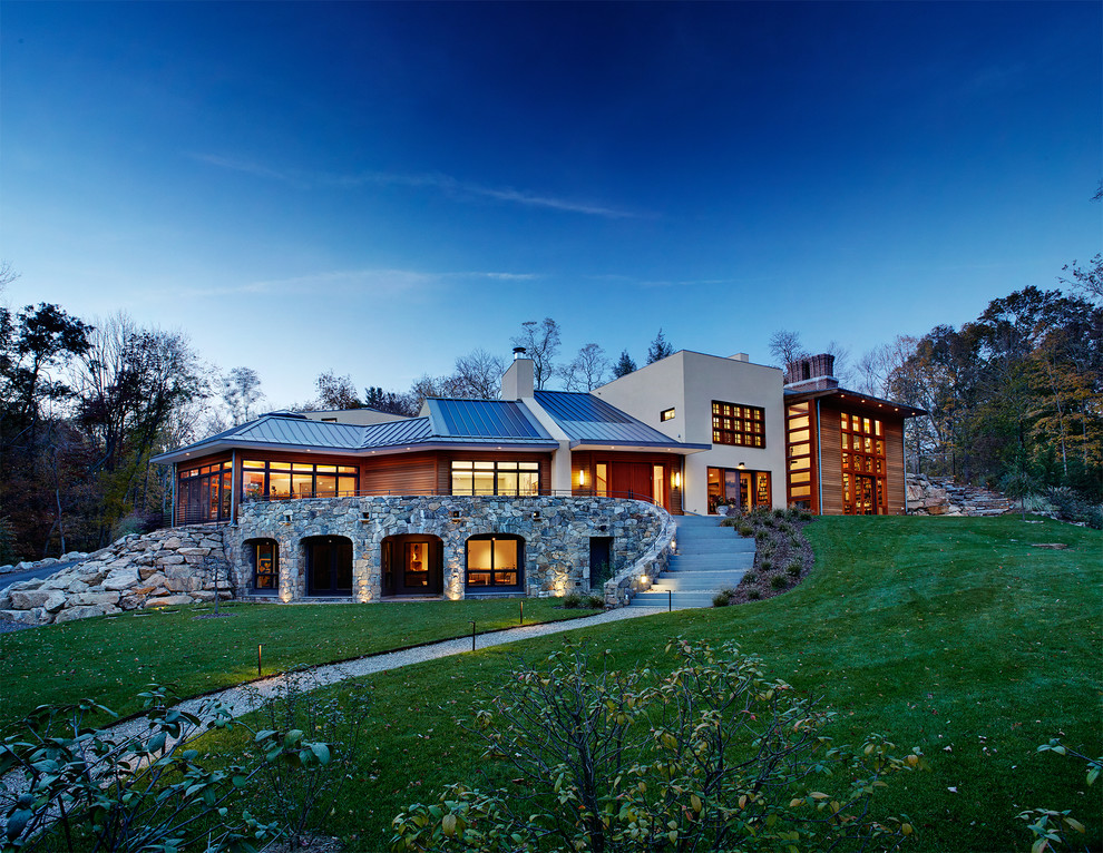 Example of a large trendy multicolored two-story mixed siding exterior home design in New York with a metal roof