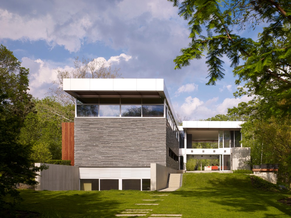 Design ideas for a modern house exterior in Chicago with three floors and a flat roof.