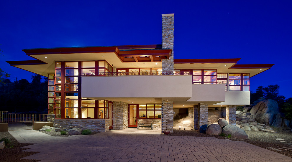 Mid-sized trendy beige two-story stone exterior home photo in Phoenix