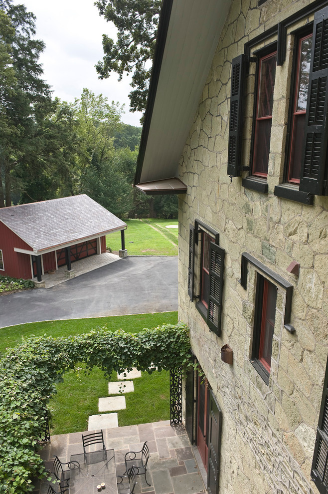 Cette image montre une façade de maison verte traditionnelle en pierre à deux étages et plus.