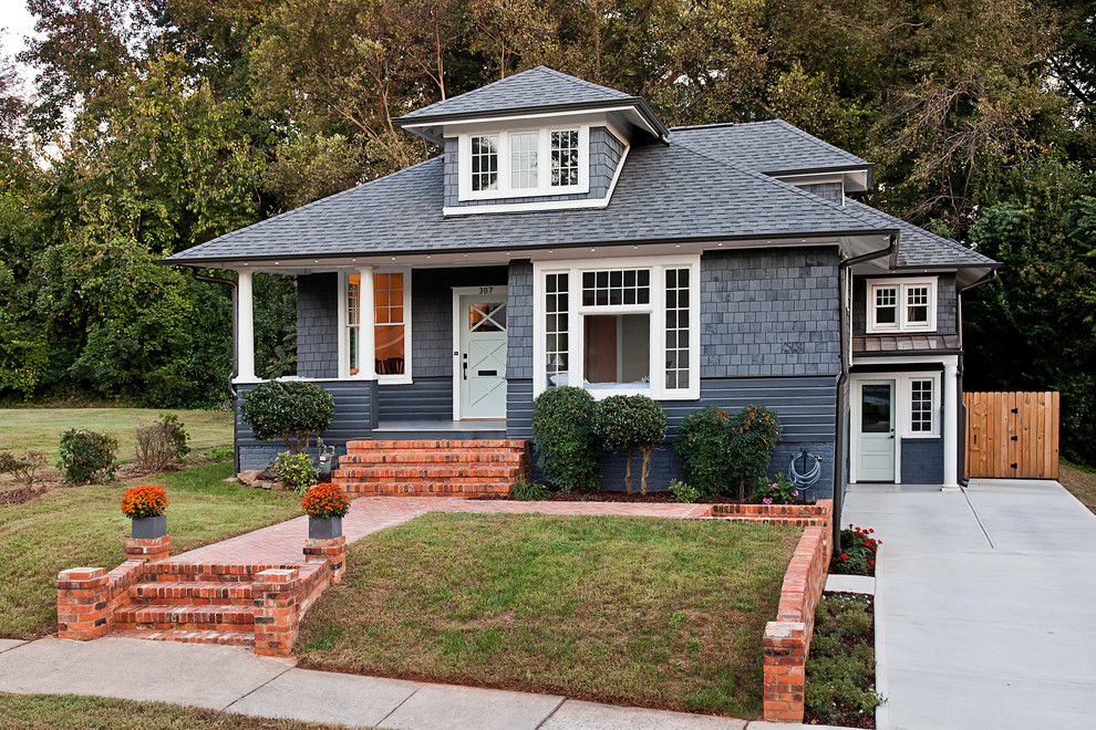 Mid-sized traditional gray two-story mixed siding house exterior idea in Charlotte with a hip roof and a shingle roof