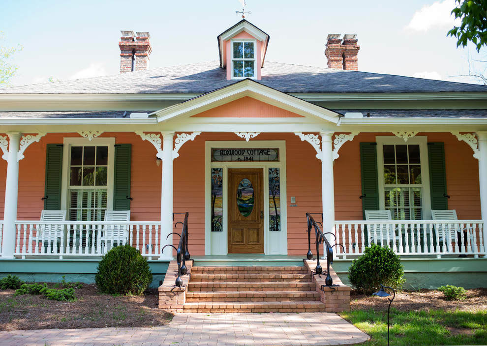 Источник вдохновения для домашнего уюта: большой, двухэтажный, деревянный, оранжевый дом в викторианском стиле с вальмовой крышей