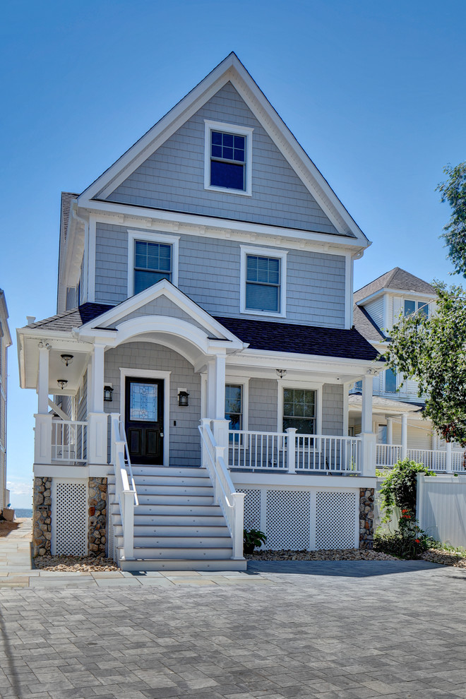 Mittelgroßes, Dreistöckiges Maritimes Einfamilienhaus mit Vinylfassade, grauer Fassadenfarbe, Walmdach und Schindeldach in Bridgeport