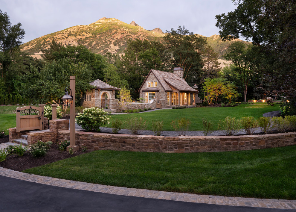 Mid-sized elegant brown one-story stone exterior home photo in Salt Lake City with a shingle roof