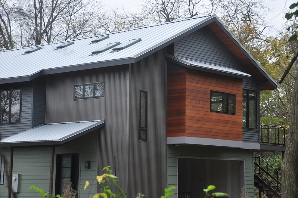 Ejemplo de fachada de casa gris contemporánea de tamaño medio de dos plantas con revestimientos combinados, tejado a dos aguas y tejado de metal