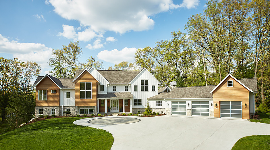 Example of a large 1960s multicolored three-story concrete fiberboard exterior home design in Grand Rapids with a shingle roof