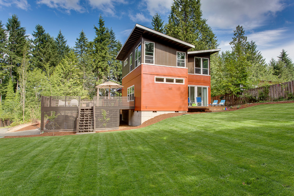 Medium sized modern two floor house exterior in Seattle with concrete fibreboard cladding and a lean-to roof.