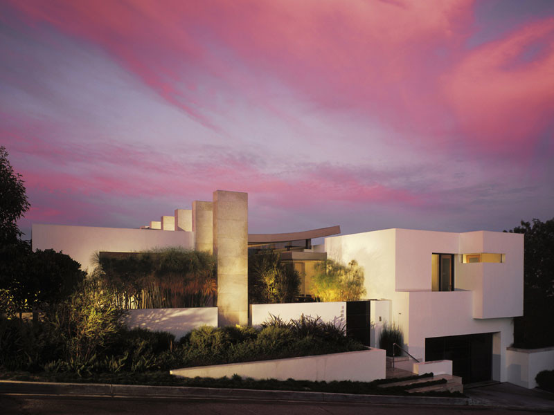 Example of a large minimalist white two-story stucco exterior home design in Los Angeles