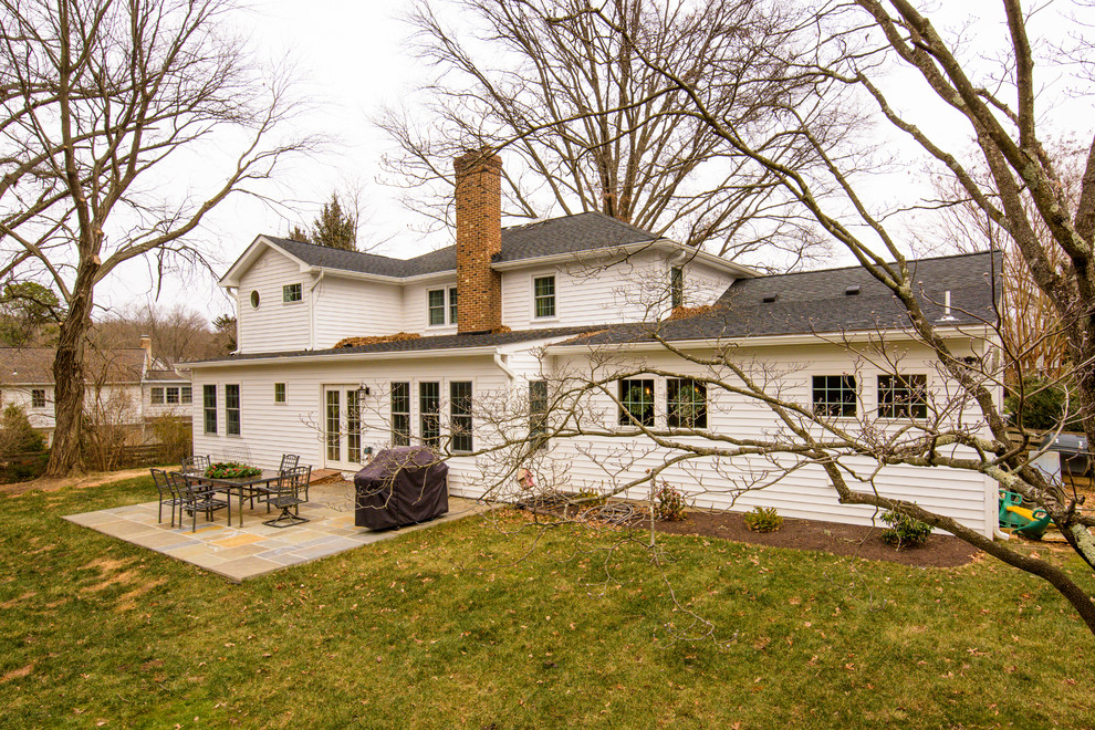 На фото: трехэтажный, белый дом среднего размера в классическом стиле с облицовкой из винила и односкатной крышей