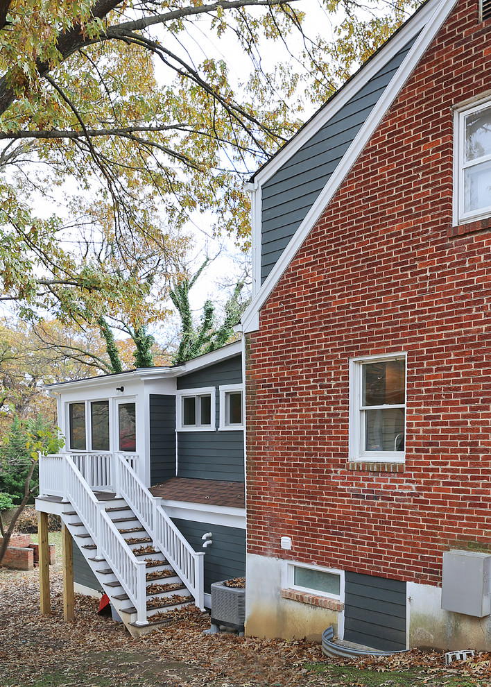 Large and blue midcentury two floor detached house in DC Metro with concrete fibreboard cladding, a pitched roof and a shingle roof.