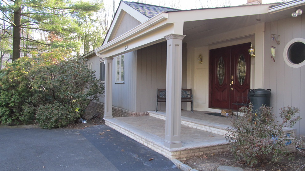 Inspiration for a large timeless beige two-story wood gable roof remodel in New York