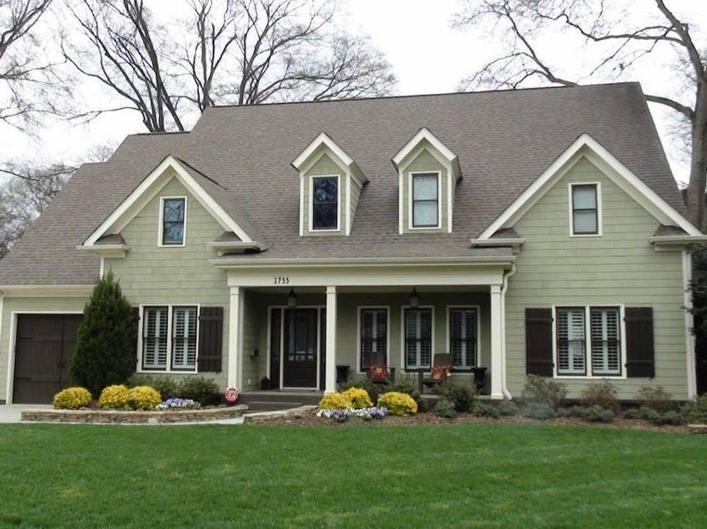 Diseño de fachada de casa verde de estilo americano de tamaño medio de dos plantas con revestimiento de aglomerado de cemento, tejado a dos aguas y tejado de teja de madera
