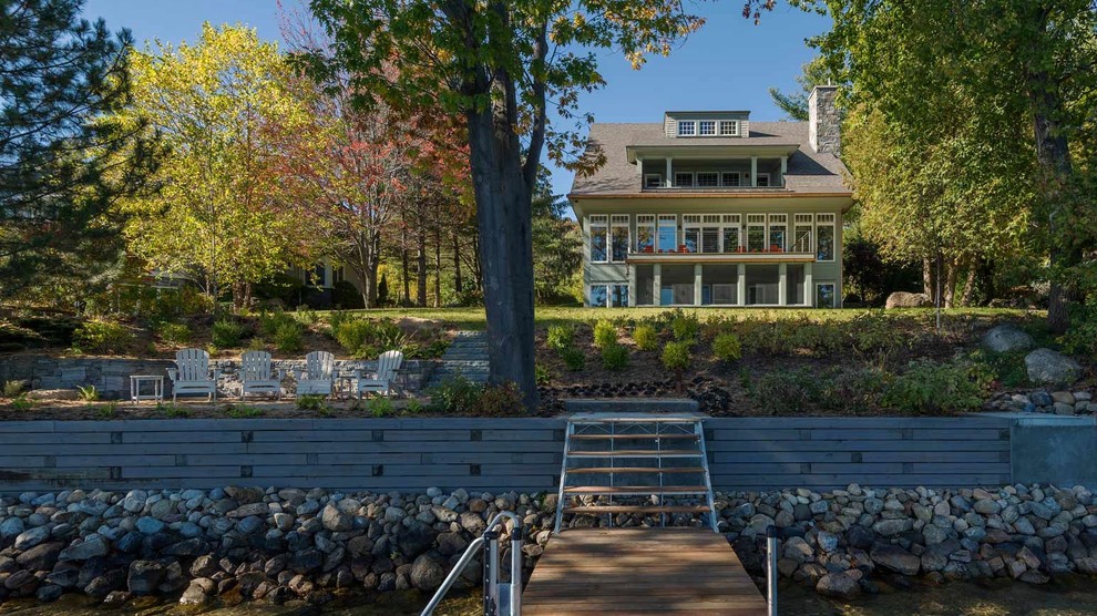 Large elegant gray three-story wood exterior home photo in Burlington with a shingle roof