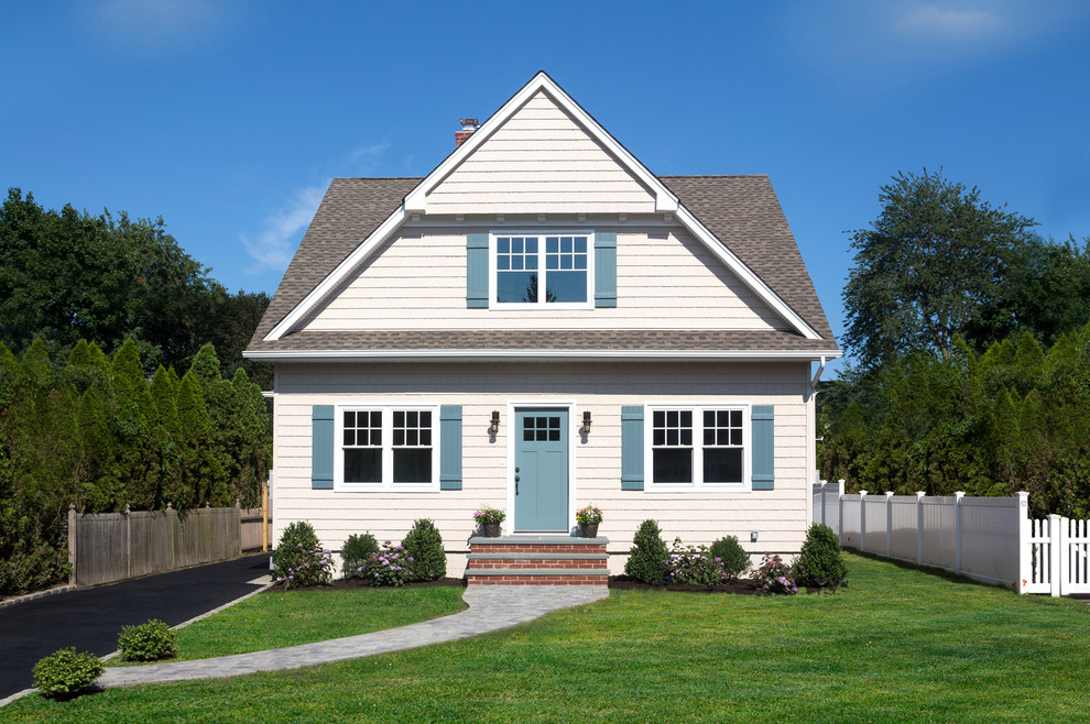 This is an example of a medium sized and beige classic two floor detached house in New York with vinyl cladding, a pitched roof and a shingle roof.