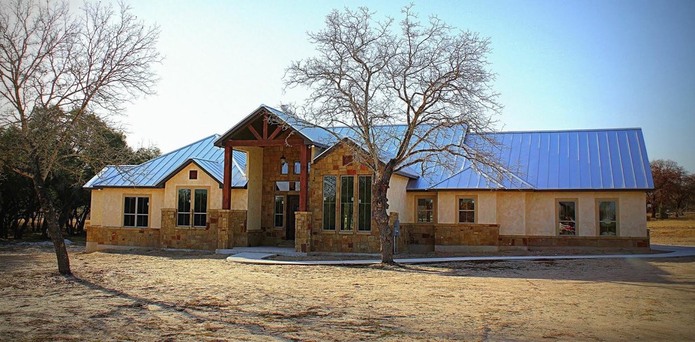 Foto de fachada beige de estilo americano de tamaño medio de dos plantas con revestimientos combinados y tejado a dos aguas
