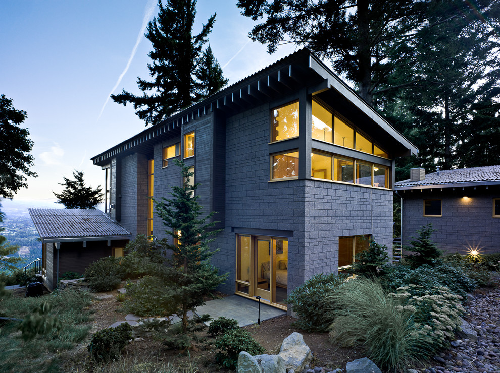 Inspiration for a contemporary two-story exterior home remodel in Portland with a shed roof