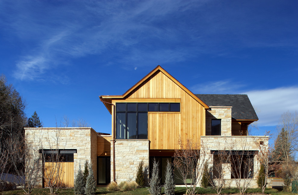 Example of a large trendy brown two-story wood exterior home design in Denver with a hip roof