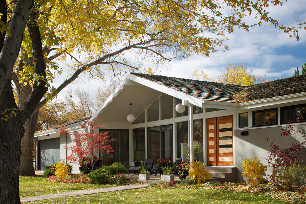 Mid-century modern gray one-story gable roof idea in Denver