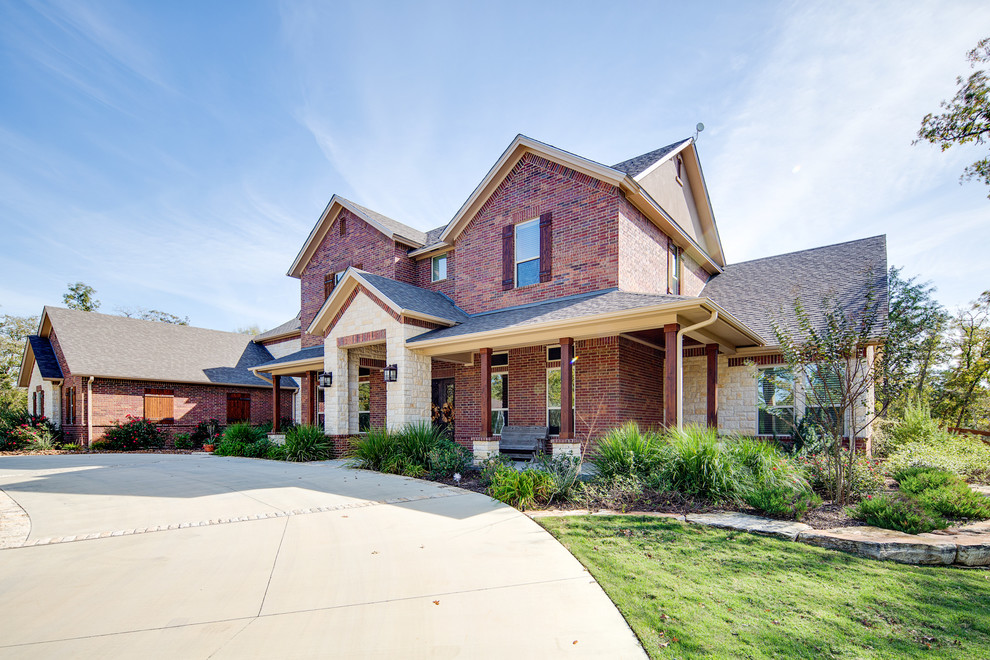 Large and brown traditional two floor brick house exterior in Austin with a pitched roof.