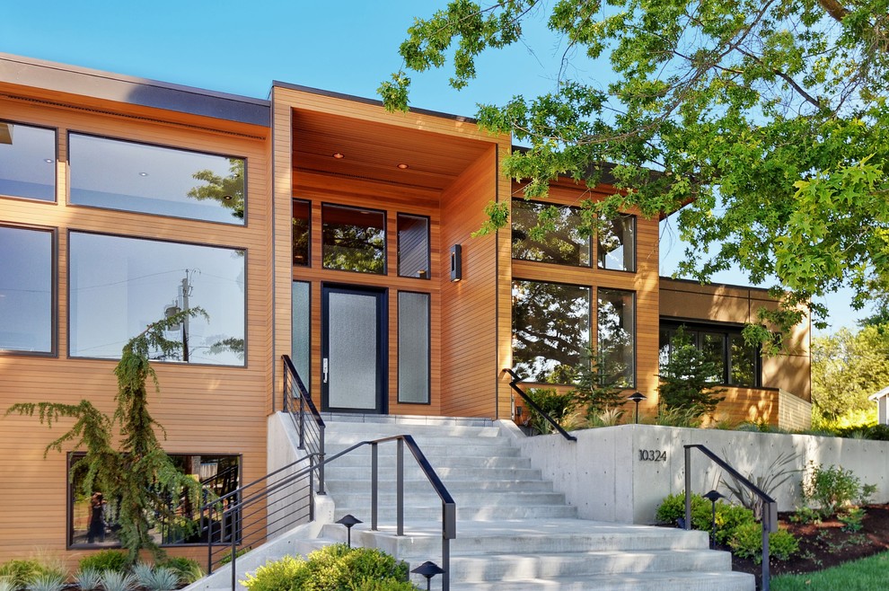 Inspiration for a medium sized contemporary two floor house exterior in Seattle with wood cladding.