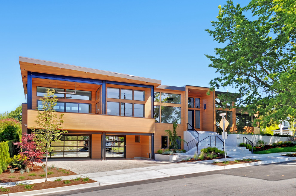 Inspiration for a contemporary two floor house exterior in Seattle with wood cladding.