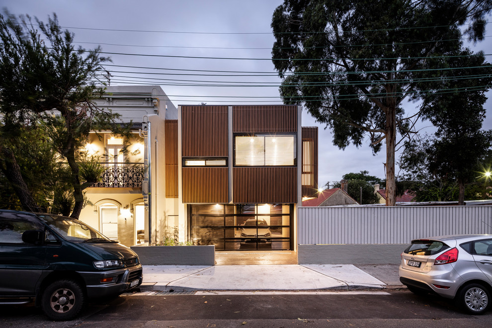 Example of a trendy green two-story wood exterior home design in Sydney