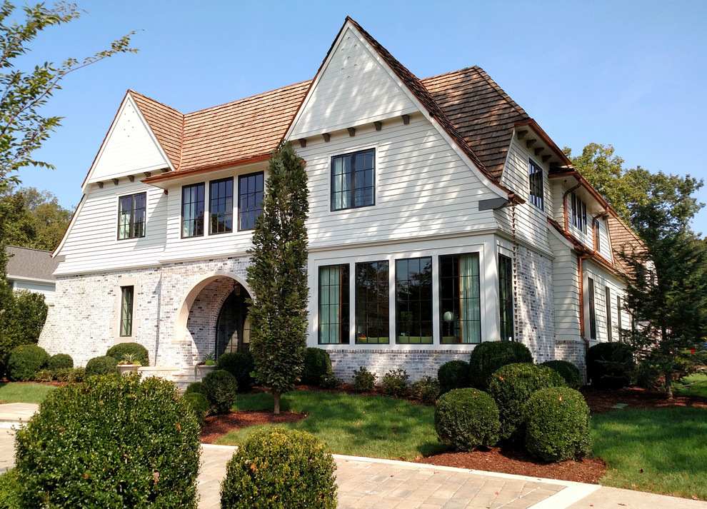 Large transitional white two-story concrete fiberboard exterior home photo in Nashville with a shingle roof
