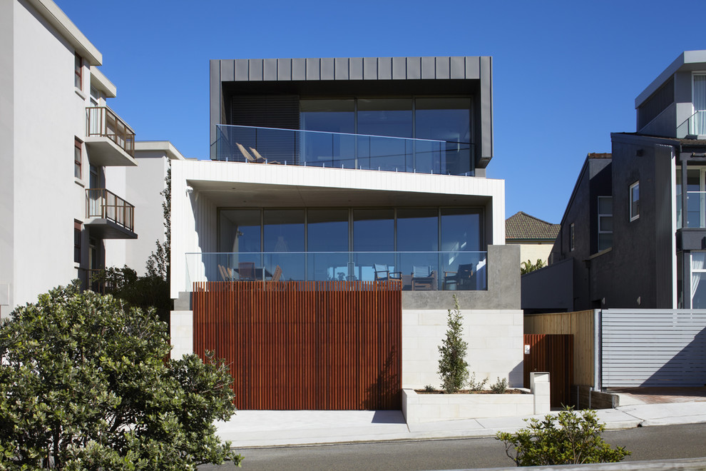 Aménagement d'une façade de maison multicolore contemporaine à deux étages et plus avec un revêtement mixte et un toit plat.