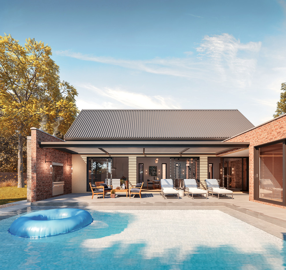 Cette photo montre une façade de maison tendance en brique de taille moyenne et de plain-pied avec un toit à deux pans et un toit en métal.