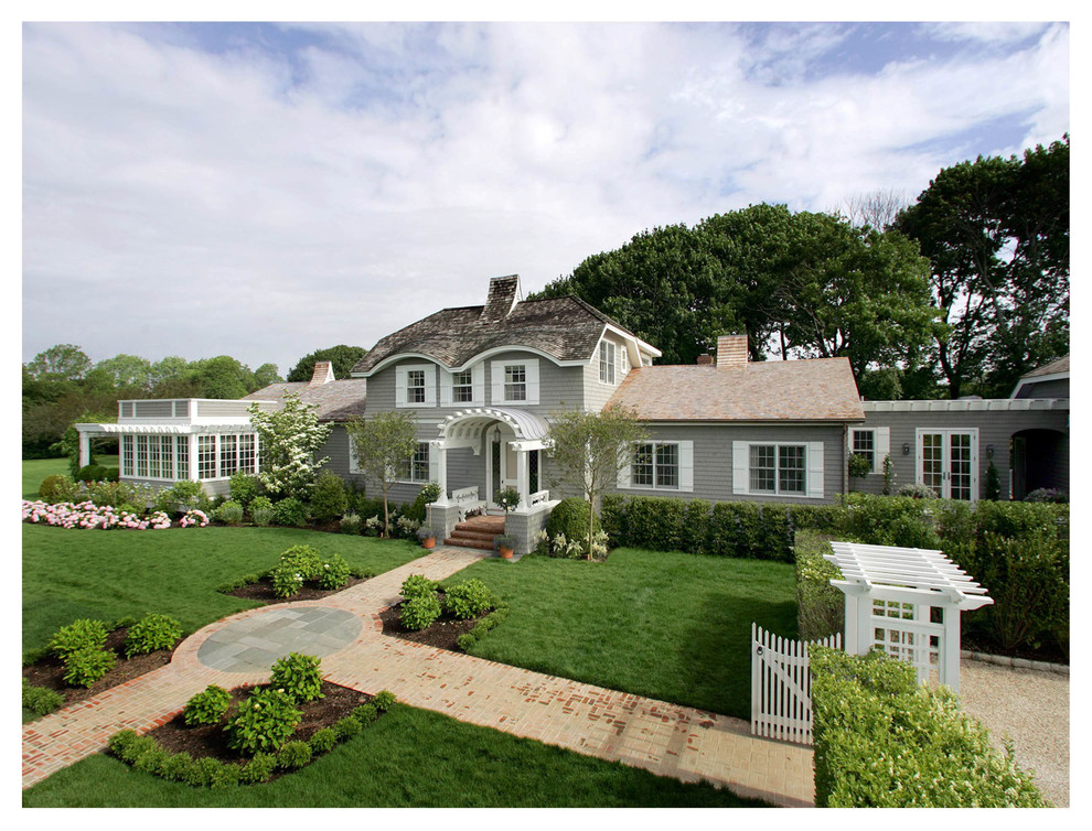 Photo of a gey traditional two floor house exterior in New York with wood cladding.