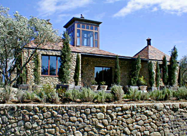 Example of a small trendy two-story stone exterior home design in San Francisco with a hip roof